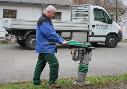 VIBRATIONSSTAMPFER zum Verdichten von lockerem Erdreich nach dem Entfernen von Hecken. Verdichten der Erde für die Montage des Sichtschutzzaunes